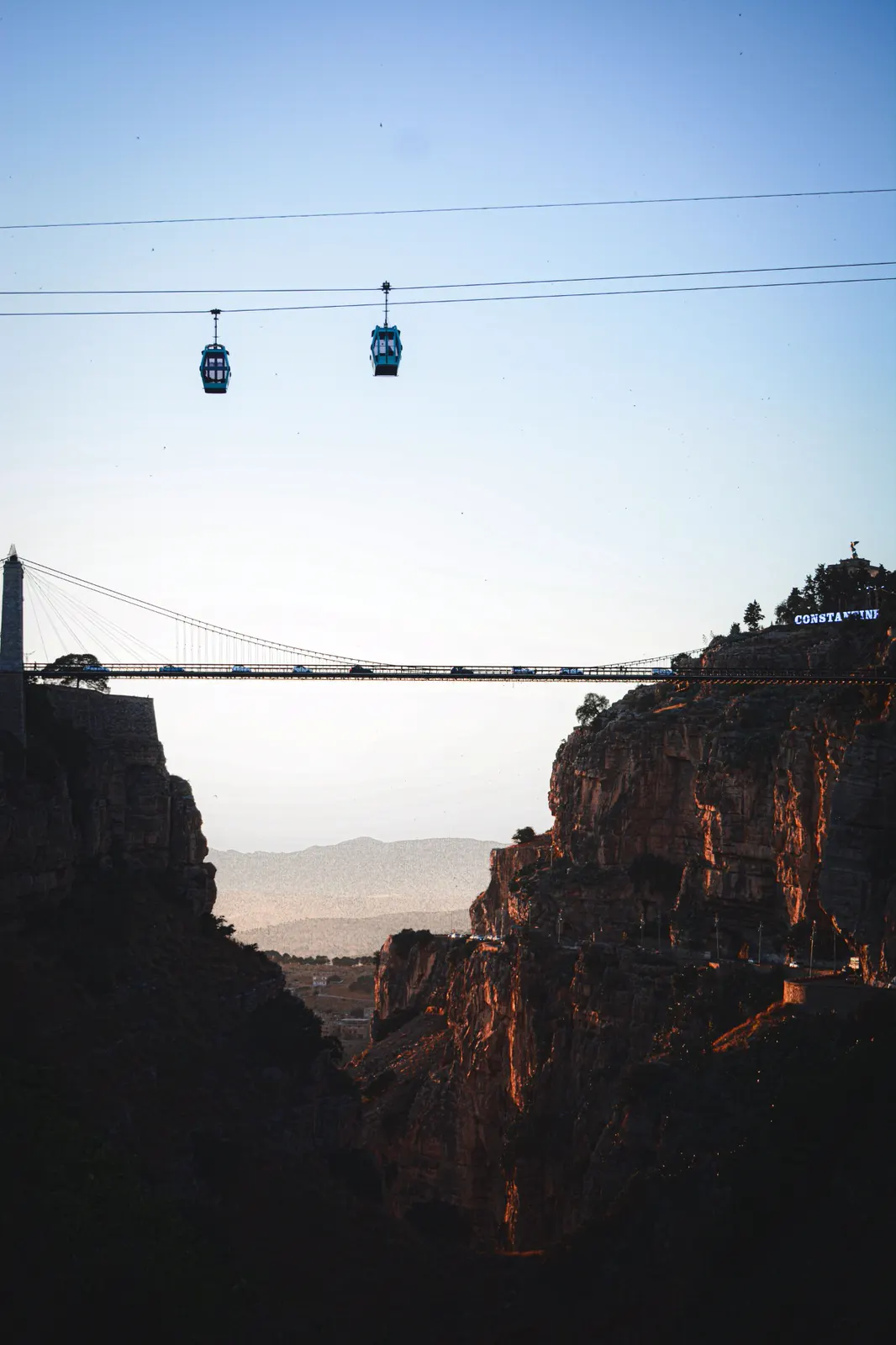 Cable cars gliding over the Sidi M'Cid bridge and the Rhumel gorge at dusk